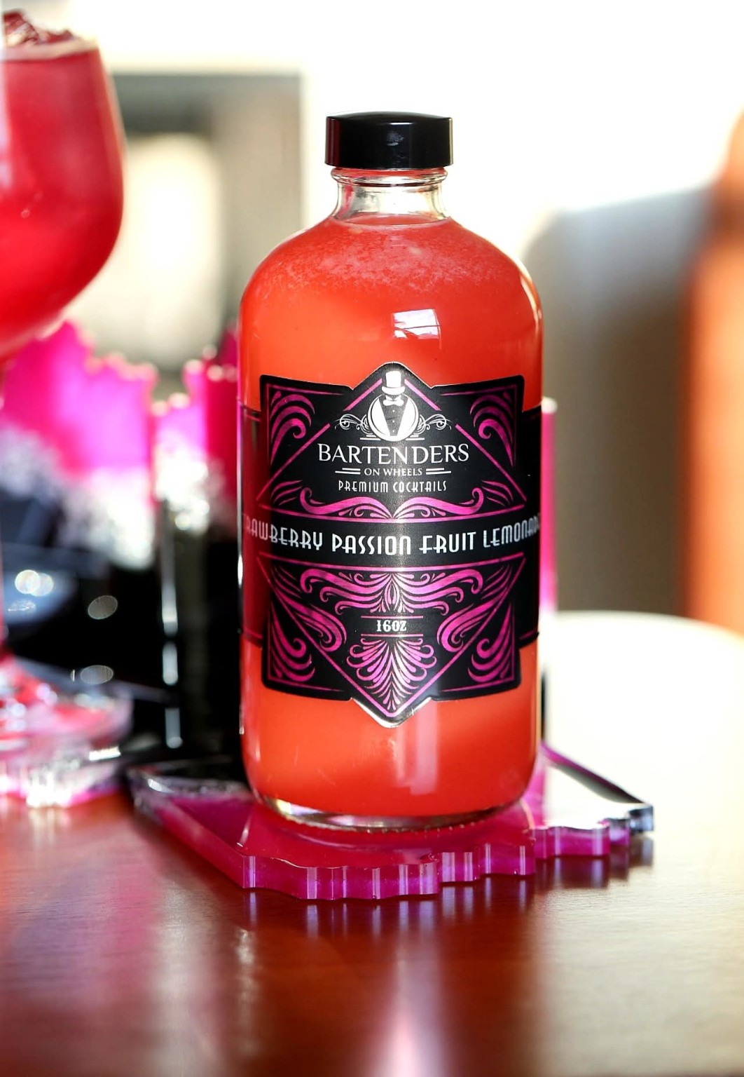 Bartenders On Wheels Strawberry Passion Fruit Lemonade bottle with its pink label.